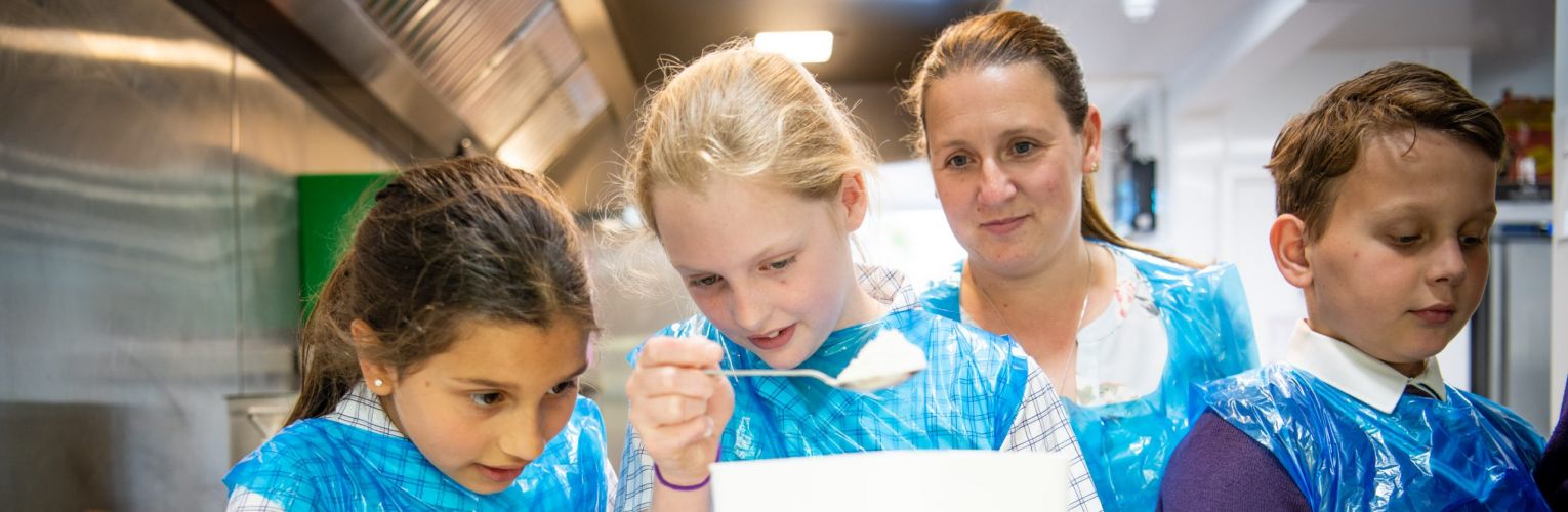 girls in the baking room measuring ingredients